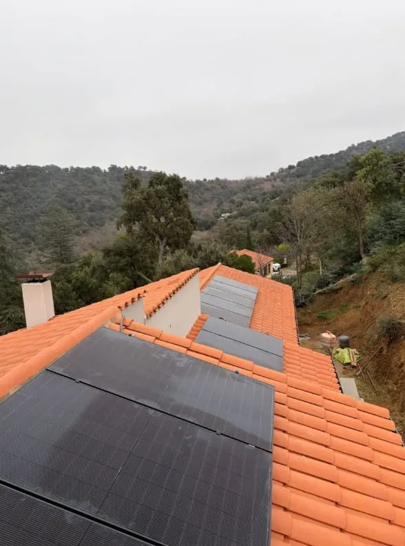 Panneaux photovoltaïques installés sur une toiture en tuiles rouges